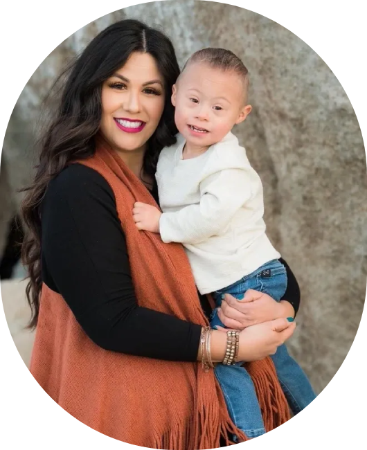 A woman holding a child and smiling