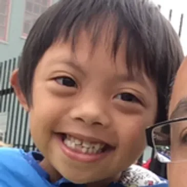 A close up of a child smiling for the camera